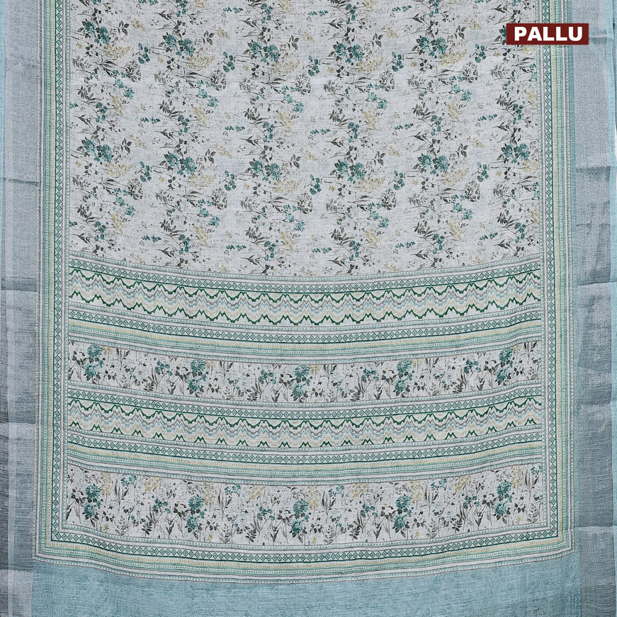 Linen cotton saree pastel teal blue with allover floral prints and silver zari woven border