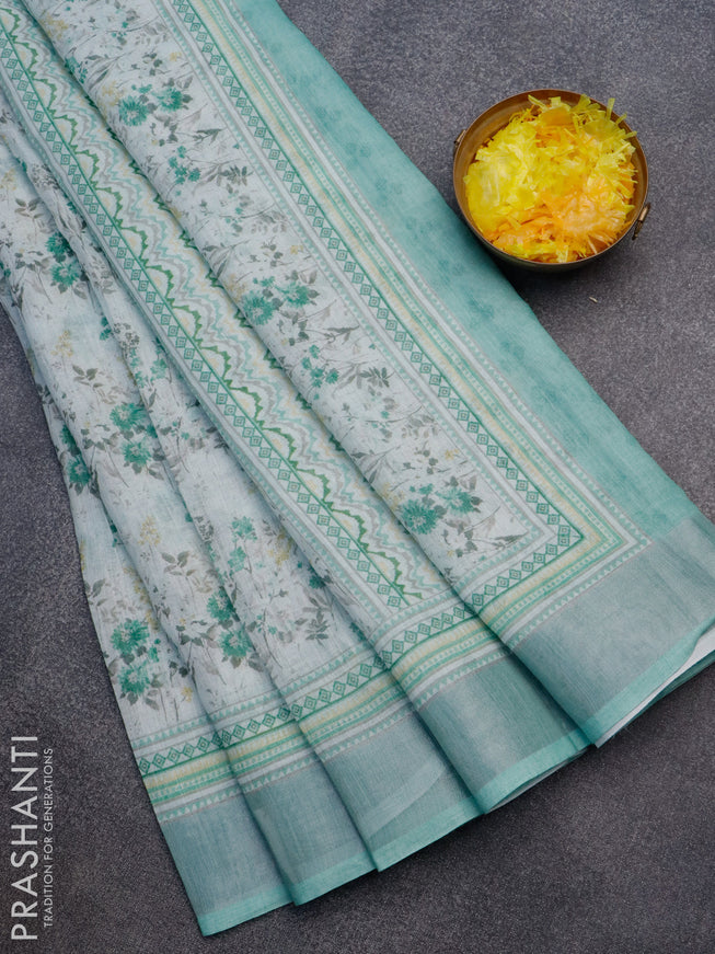 Linen cotton saree off white and green shade with allover floral prints and silver zari woven border