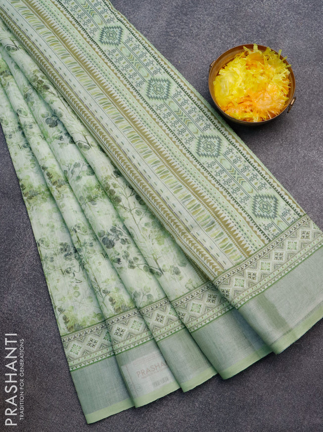 Linen cotton saree light green with allover prints and silver zari woven border
