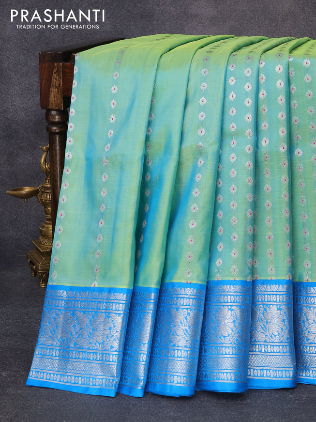 Venkatagiri silk saree dual shade of teal bluish green and cs blue with allover silver zari buttas and floral silver zari woven border