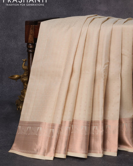 Pure kanjivaram silk saree cream and lavender with allover self emboss & zari buttas and copper zari woven border