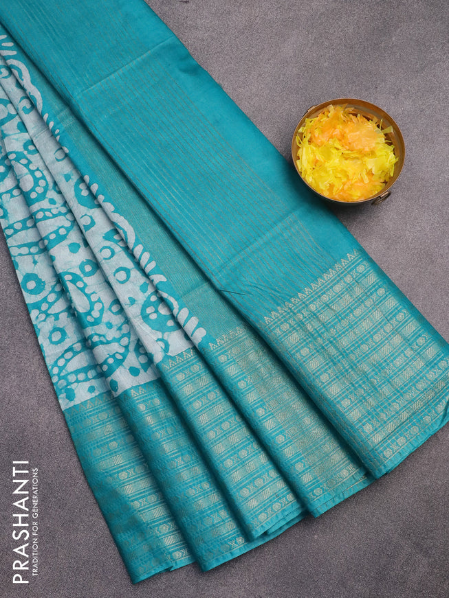 Semi tussar saree teal green with allover batik prints and long zari woven border