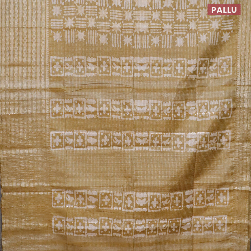 Semi tussar saree mehendi green and beige with allover batik prints and long silver zari woven border