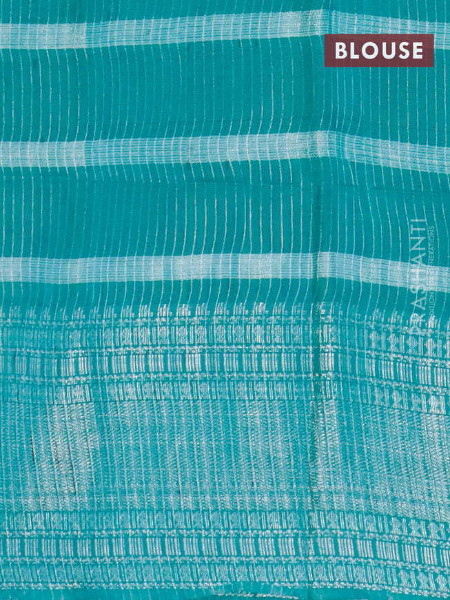 Semi tussar saree teal green with allover batik prints and long silver zari woven border