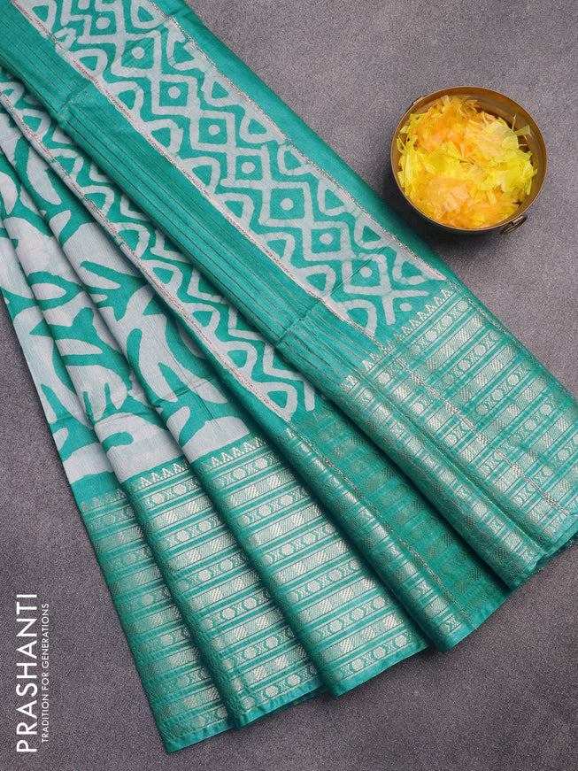 Semi tussar saree off white and teal blue shade with allover batik prints and long zari woven border