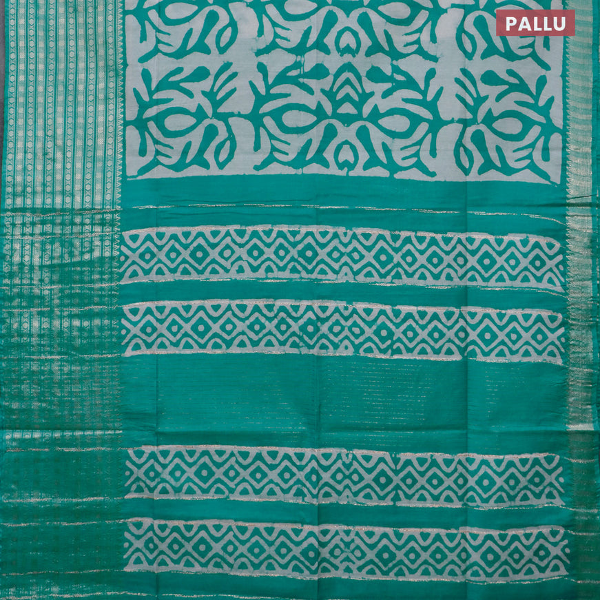 Semi tussar saree off white and teal blue shade with allover batik prints and long zari woven border