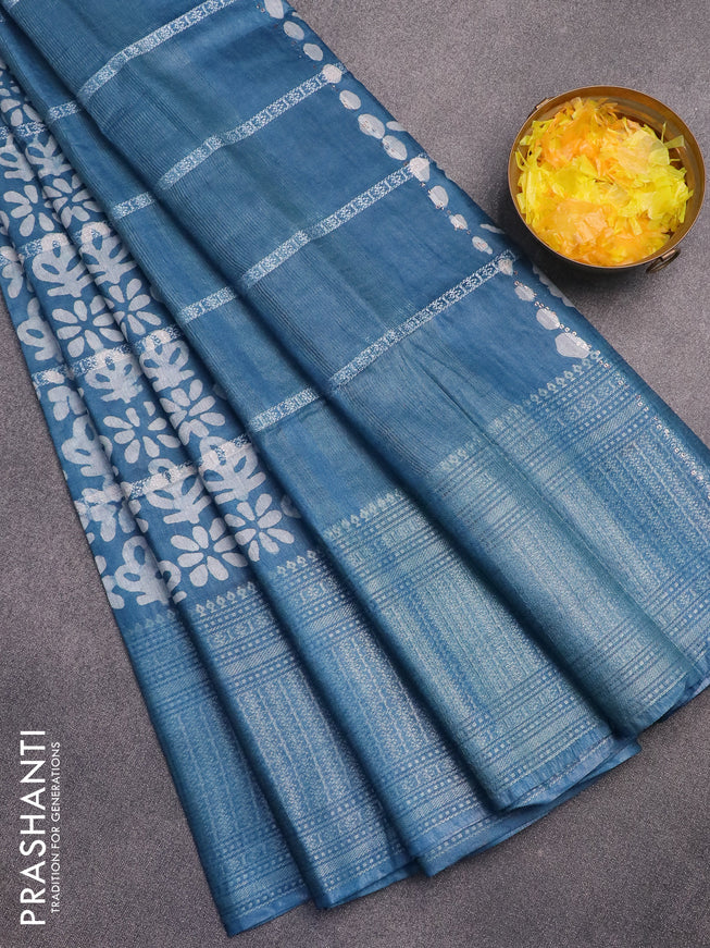 Semi tussar saree cs blue with allover batik prints and long silver zari woven border