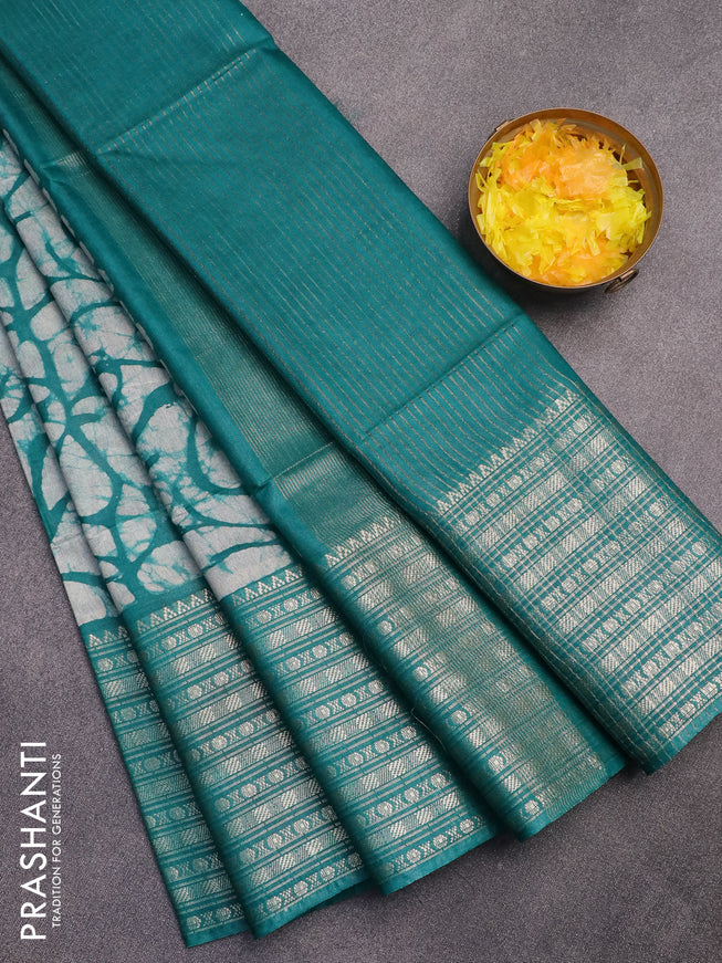 Semi tussar saree off white and teal green with allover batik prints and long zari woven border
