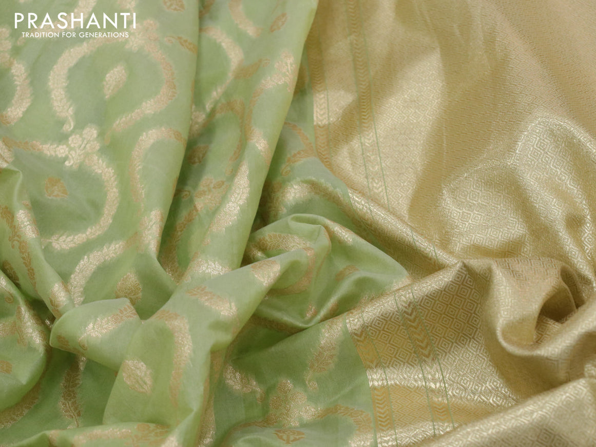 Banarasi cotton saree pista gteen with allover zari weaves and floral embroidery border