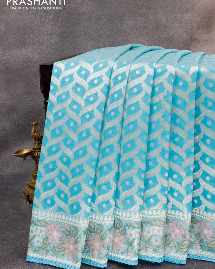 Banarasi cotton saree light blue with allover silver zari weaves and zari woven floral embroidery work border