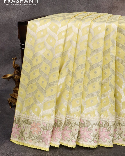 Banarasi cotton saree pale yellow with allover silver zari weaves and zari woven floral embroidery work border