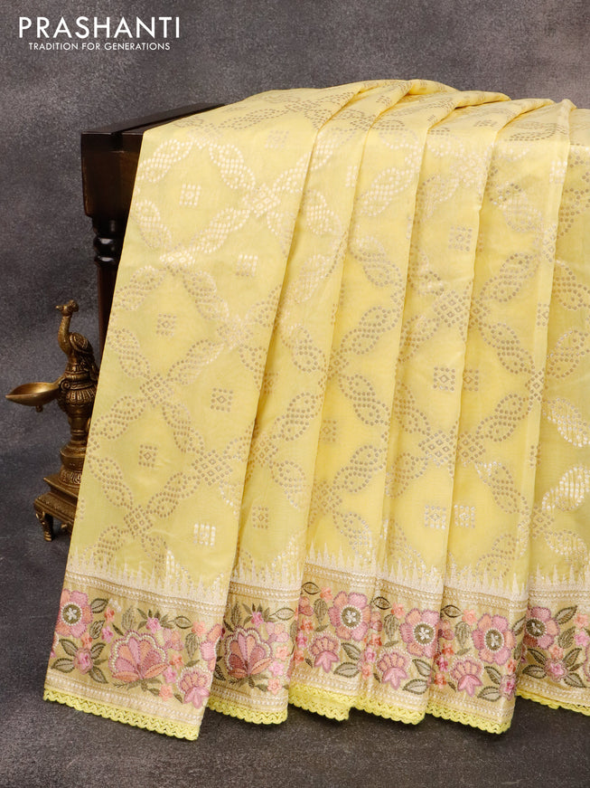 Banarasi cotton saree pale yellow with allover zari weaves and zari woven floral embroidery work border