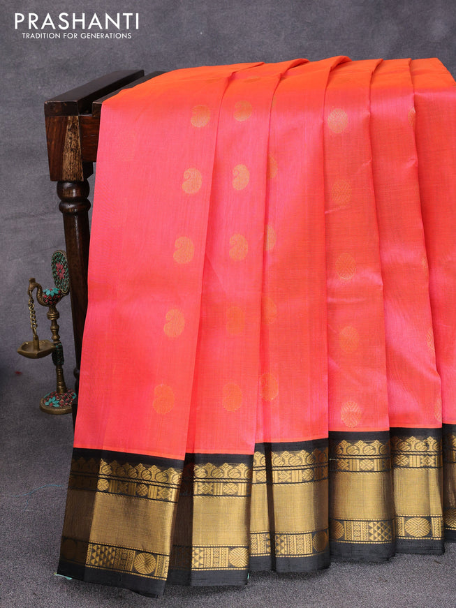 Kuppadam silk cotton saree dual shade of pinkish orange and black with zari woven buttas and rich zari woven border