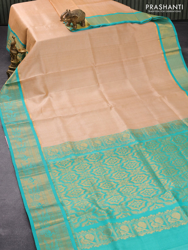 Kuppadam silk cotton saree sandal and teal blue with allover zari checked pattern and zari woven peacock border