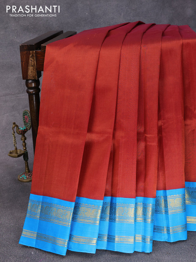 Silk cotton saree rustic brown and cs blue with plain body and rettapet zari woven korvai border