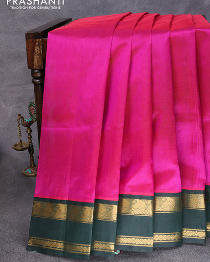 Silk cotton saree magenta pink and dark green with plain body and paisley rettapet zari woven korvai border