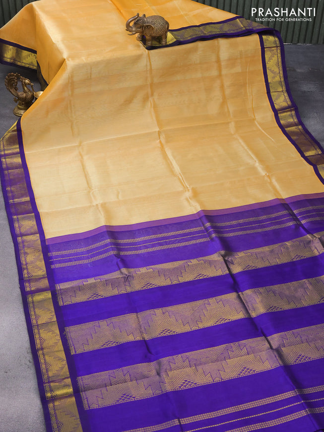 Silk cotton saree pale yellow and blue with plain body and temple design zari woven korvai border