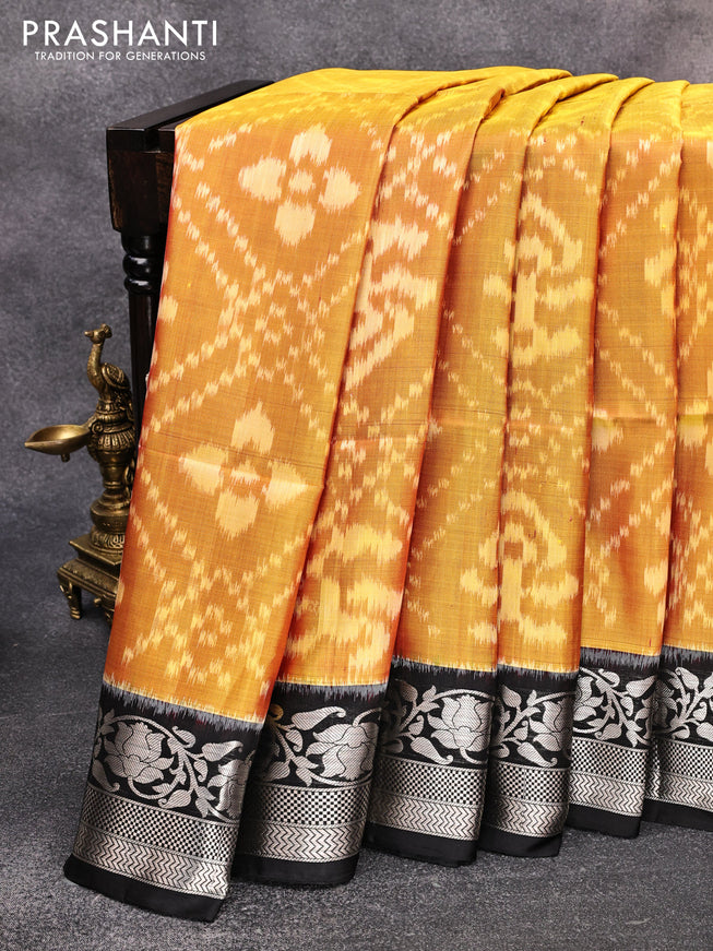 Ikat soft silk saree dual shade mustard yellow and black with allover ikat weaves and floral silver zari woven border