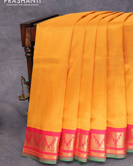 Silk cotton saree dark mustard and red with plain body and temple design zari woven korvai border