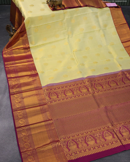 Pure kanjivaram tissue silk saree pale yellow and deep purple with zari woven buttas and long zari woven annam border & tissue