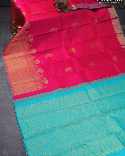 Pure kanjivaram silk saree dual shade of pinkish orange and teal blue with paisley zari woven buttas and long zari woven border & butta style