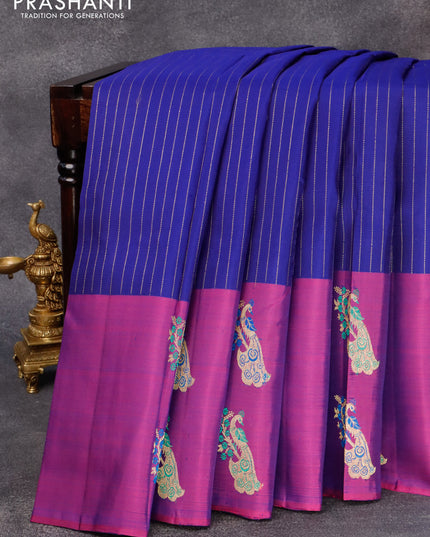 Pure kanjivaram silk saree blue and dual shade of purple with allover zari woven stripes pattern and peacock zari woven butta border & allover weaves