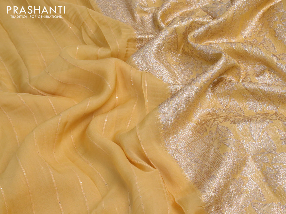 Chinon silk saree yellow shade with allover sequin work and zari woven floral border & zari butta blouse