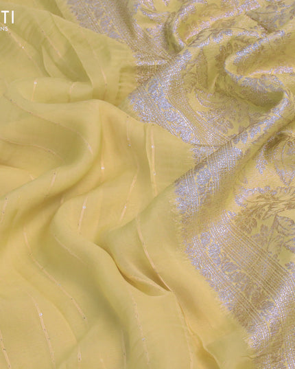 Chinon silk saree pale yellow shade with allover sequin work and zari woven floral border & zari butta blouse