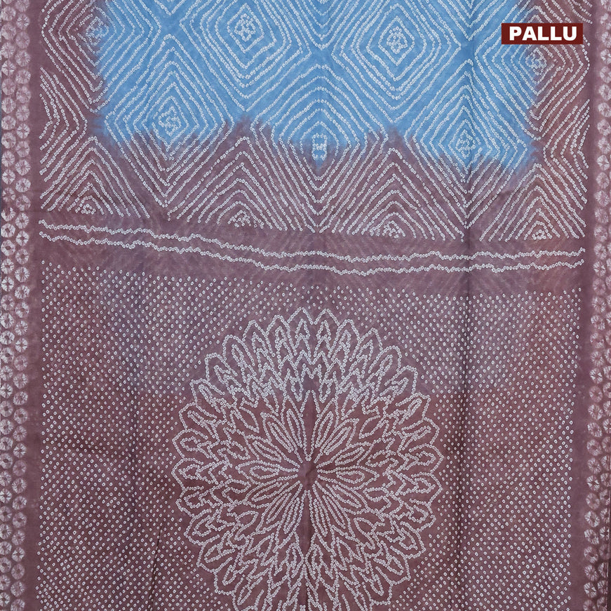 Semi linen saree light blue shade and brown with allover bandhani prints and batik printed border