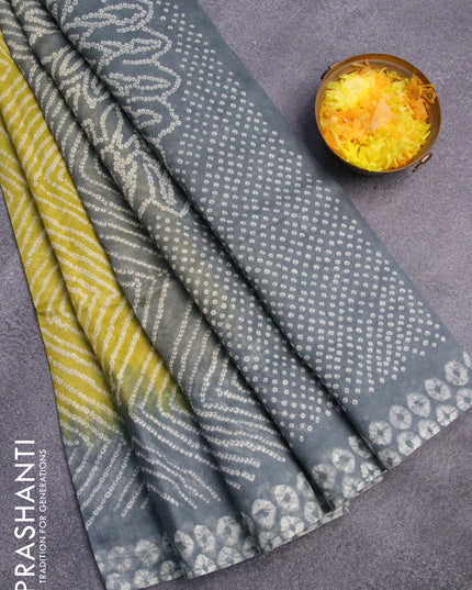 Semi linen saree lime yellow and pastel grey with allover bandhani prints and batik printed border