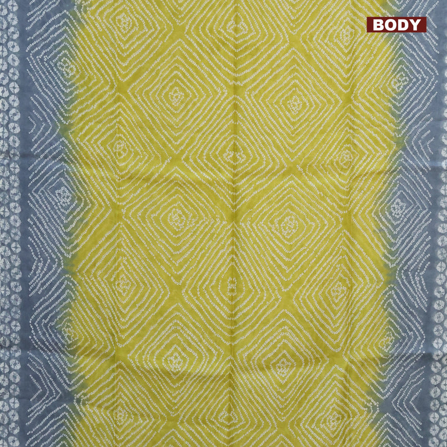Semi linen saree lime yellow and pastel grey with allover bandhani prints and batik printed border