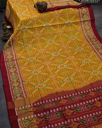 Rajkot patola silk saree mustard yellow and maroon with allover ikat weaves and zari woven ikat style border