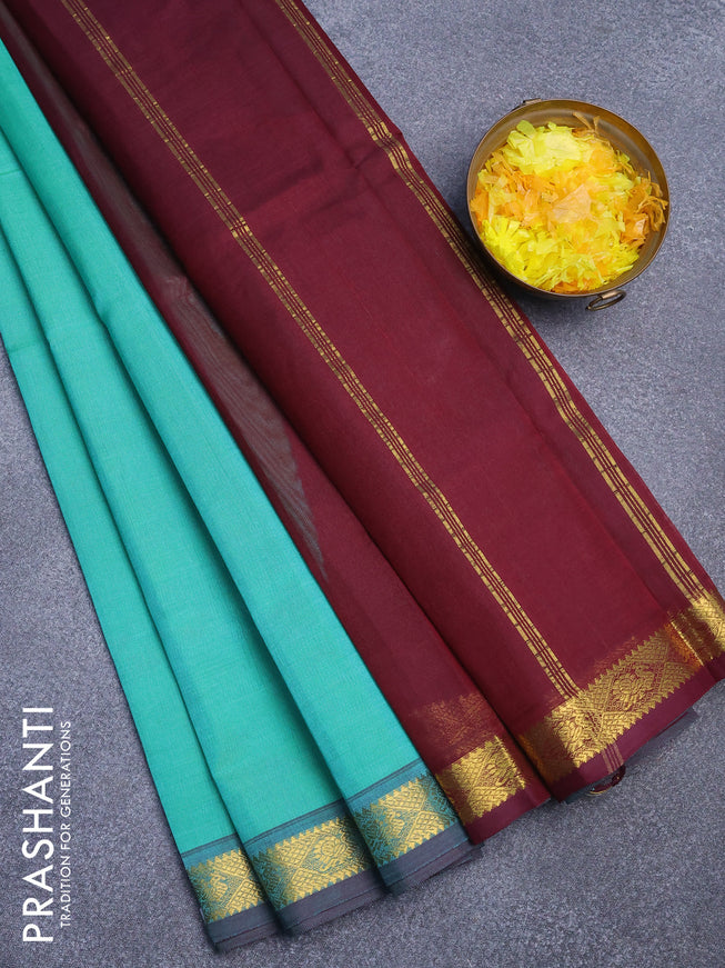 Silk cotton saree teal green and deep maroon with plain body and small zari woven border