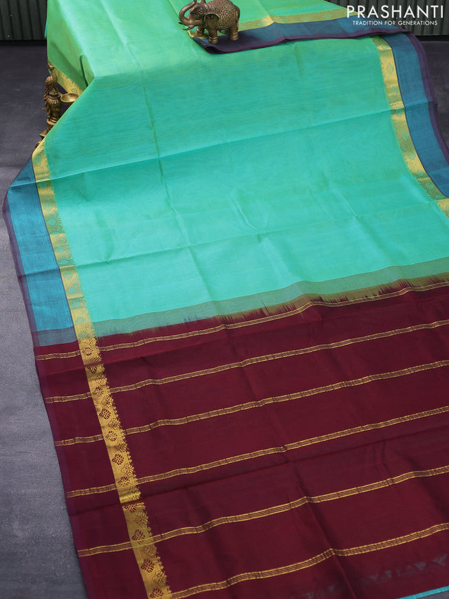 Silk cotton saree dual shade of teal green and wine shade with plain body and zari woven simple border