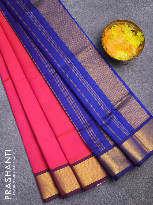 Silk cotton saree dual shade of pinkish orange and blue with plain body and zari woven border