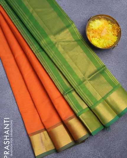 Silk cotton saree orange and green with plain body and zari woven border