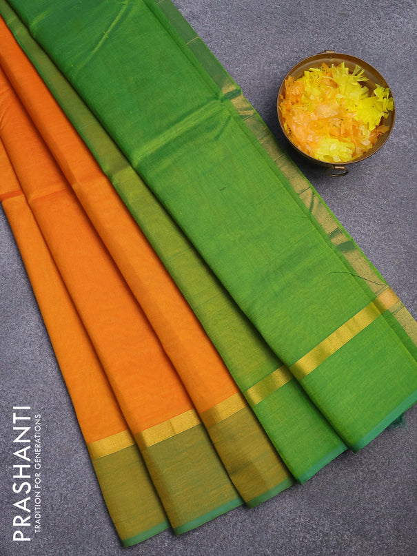 Silk cotton saree orange and light green with plain body and zari woven simple border