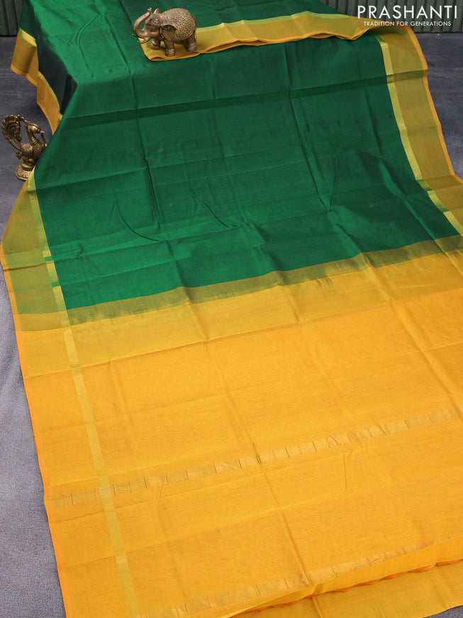 Silk cotton saree green and mustard yellow with plain body and zari woven simple border