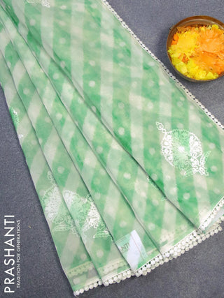 Semi orangza saree off white and green with allover ikat prints & embroidery buttas and crocia lace border