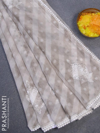 Semi orangza saree off white and grey with allover ikat prints & embroidery buttas and crocia lace border