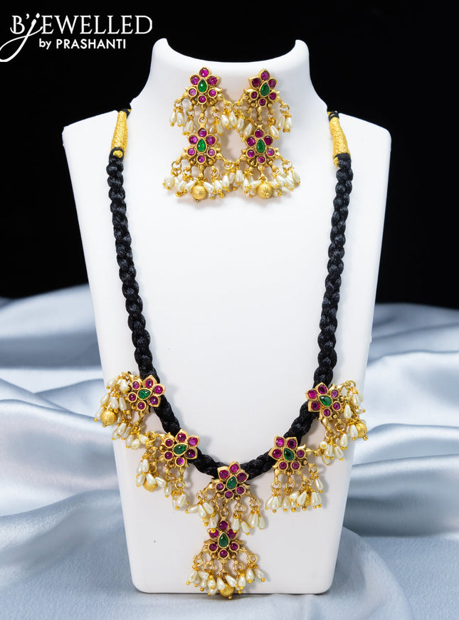Black thread necklace with kemp stone and golden beads hanging