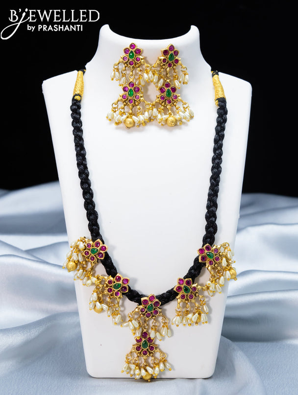 Black thread necklace with kemp stone and golden beads hanging