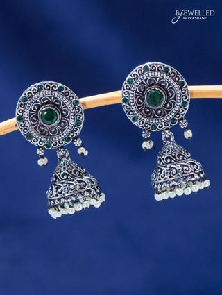 Oxidised jhumka with emerald stones and pearl hangings
