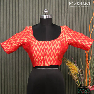 Readymade brocade blouse orange with allover ikat zari weaves and back knot
